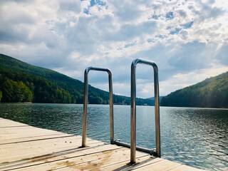 Wooden pontoon on the lake in summer