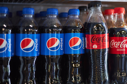 Competing plastic soda bottles on one shelf at supermarket store. Pepsi and Coca Cola brand zero, classic. Beverage, popular carbonated soft drinks selective focus. Bishkek, Kyrgyzstan - 26 May 2023. 