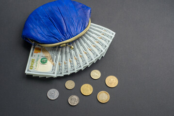 High Angle View Of Coins And Wallet With Paper Currency On the Blue Background
