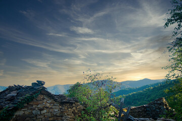 A charming autumn scene featuring a cozy house nestled amidst vibrant trees adorned with colorful foliage. Sunlight filters through the leaves, casting warm, dappled shadows on the roof and