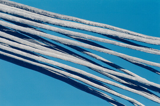 The dried bones of a dead saguaro against a pale blue sky in the Tucson, Arizona desert.