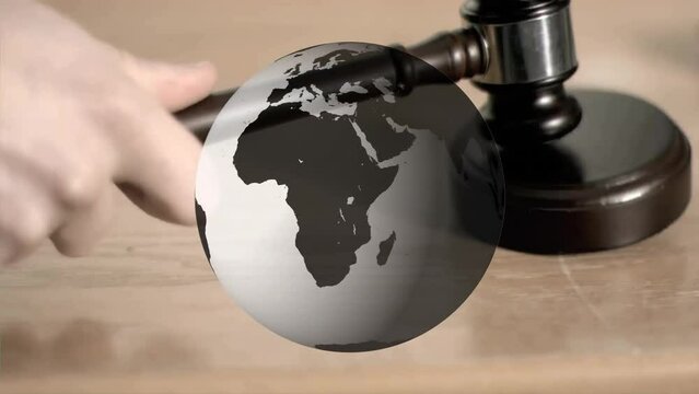 Animation of spinning globe over hand using gavel