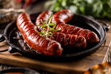 Sausages fried with spices bbq sauce and herbs - Close up