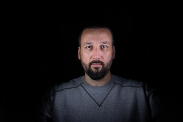 portrait for man in dark and light in middle age with face expression