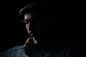 man thinking in dark and light portrait