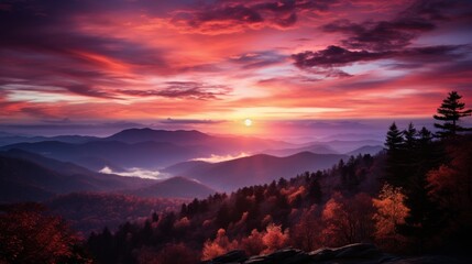 Fototapeta na wymiar Dramatic sunrise over misty mountains with a spectrum of red and purple clouds