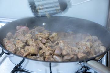 Cooking chicken gizzard livers and hearts using pan