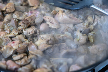 Cooking chicken gizzard livers and hearts using pan