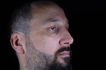 Obraz premium portrait for man in dark and light in middle age with face expression