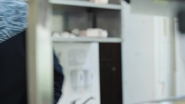 Gourmet cook is dealing with the preparation of seafood ingredients. Gourmet cooks fish ingredients for tasty dish. A gourmet cook is picking the bones out of the raw fish in the kitchen