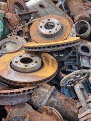 A pile of scrap metal on a junkyard. The photo shows a pile of scrap metal on a junkyard. The scrap metal consists of various objects, such as car parts, old appliances, and pieces of machiner