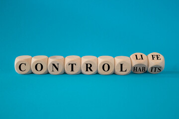 Control habits and life symbol. Concept words Control habits to Control life on beautiful wooden cubes. Beautiful blue background, copy space. Business control habits and life concept.