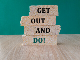 Motivational get out and do symbol. Concept words Get out and do on brick blocks. Beautiful green...