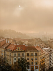 Fototapeta na wymiar Foggy sunny sunset in Prague, clouds, panoramic city view