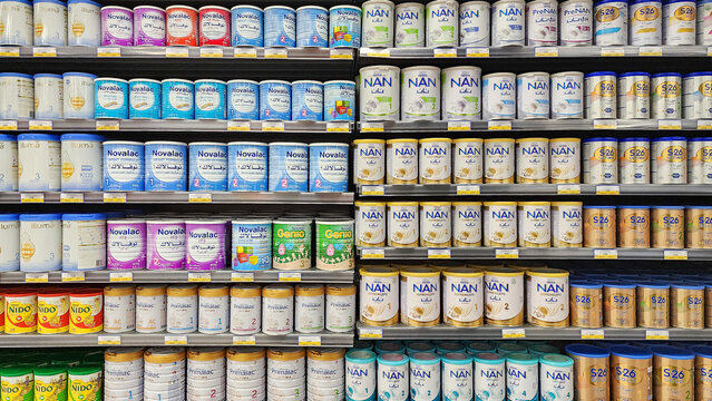 Various baby formula at a shelf of supermarket.