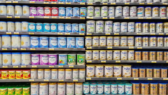 Various baby formula at a shelf of supermarket.