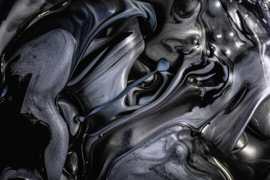 Monochromatic abstract of black and gray swirling inks with subtle bubbles, creating a mysterious and fluid metallic texture