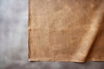 
view of brown tablecloth for food on cement background. space for design