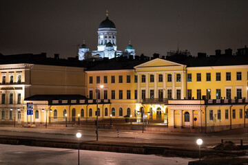 Fototapeta na wymiar Helsinki Presidential palace during night-time with Helsinki cathedral shining in the background