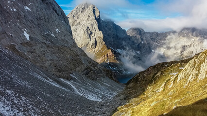 Panoramic view of alpine lake Wolayersee surrounded by majestic Carnic Alps, Carinthia, border Italy Austria. Scenic hiking trail in wilderness of Austrian Alps. Peace of mind, calmness, wanderlust