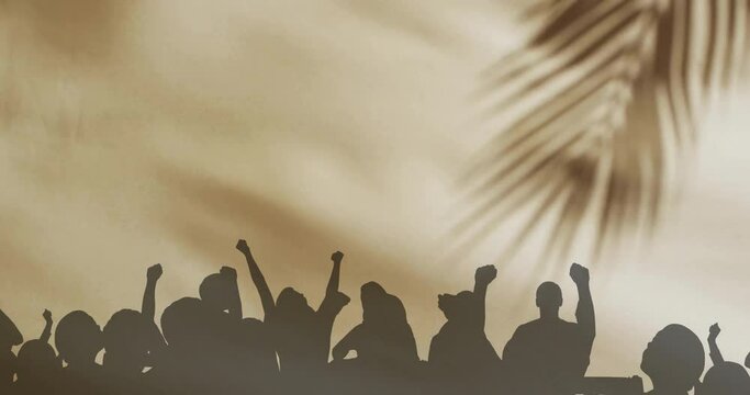 Animation of silhouettes of people jumping and floating cloth over palm tree