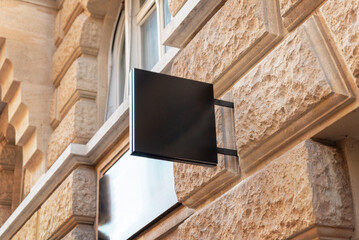 Clean black square sign in a modern city street, providing a perfect spot for logo promotion and...