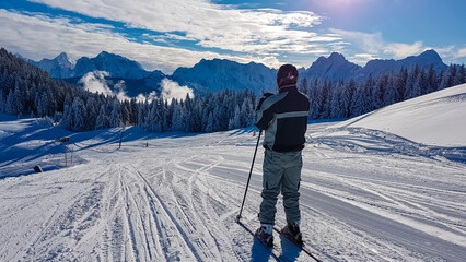 Male skier on powder snow in ski resort Dreilaendereck in Karawanks, Carinthia, Austria. Alpine...