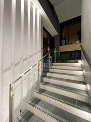 Indoor staircase with backlighting and glass railing