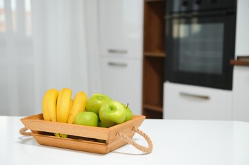 handmade kraft box with fruits and vegetables on kitchen background.