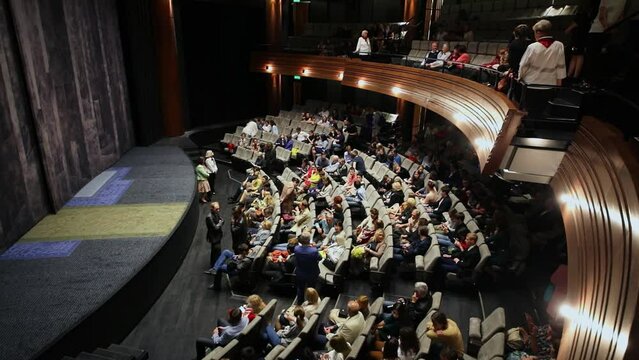  Lot of people wait for begin of next act during intermission in Cherry Garden theater