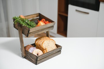 handmade kraft box with fruits and vegetables on kitchen background.