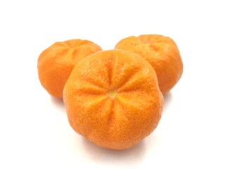 Closeup of photo of three juice mandarines from the Greek island of Chios, isolated on white background.