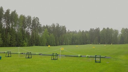 Starting area with baskets and balls on golf course in rainy weather
