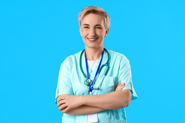 Mature female nurse on blue background
