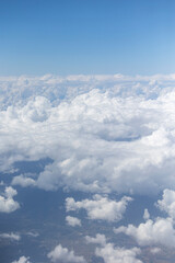 View from the airplane window, clouds, land, and sky