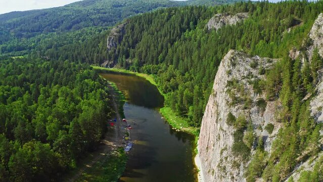 4k drone footage of Agidel river in Ural mountains landscape. Rafting season on a river in summer