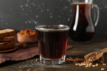 Glass of tasty kvass on table