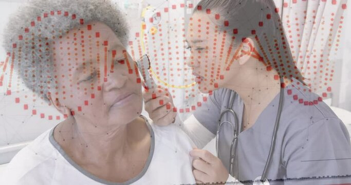 Animation of dna on interface over diverse female doctor checking ear of senior female patient