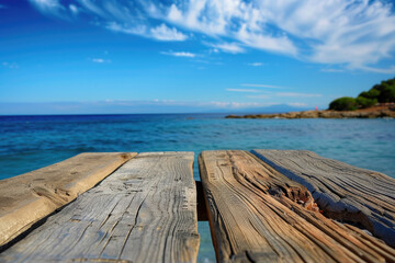Naklejka na ściany i meble A wooden table set against the backdrop of the sea, an island, and the blue sky