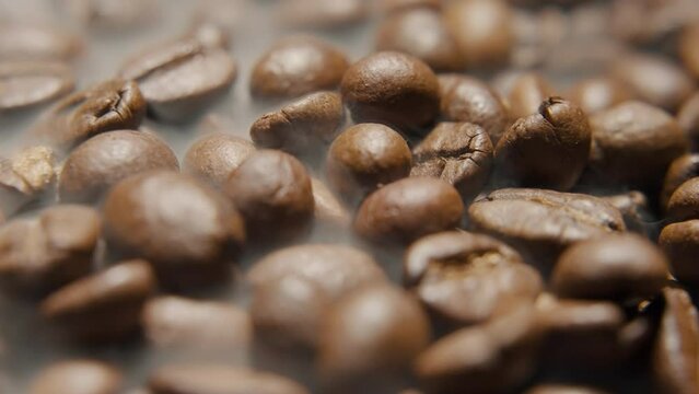 Coffee beans in smoke in 360 degree rotating showcase macro shot