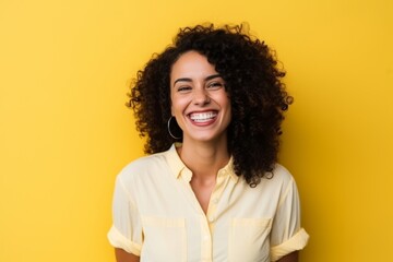 Portrait of a beautiful young african american woman laughing over yellow background - obrazy, fototapety, plakaty