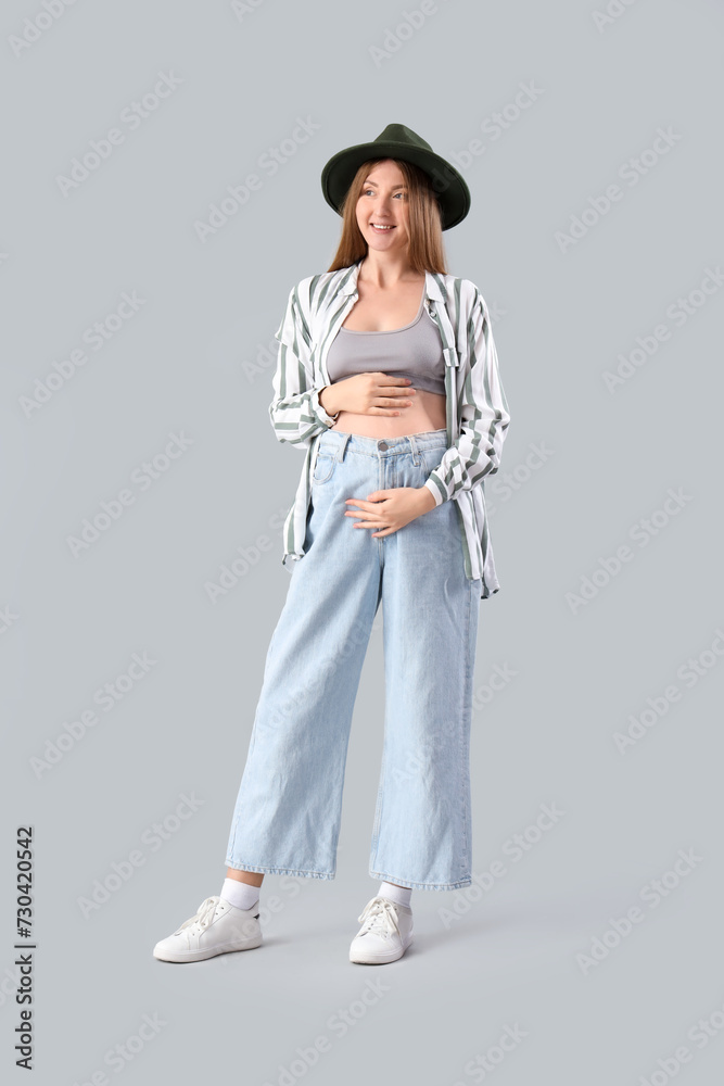 Canvas Prints Stylish young pregnant woman on light background