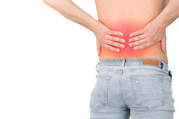 Naklejka premium Rear view of a shirtless handsome young man holding his back in pain isolated on white background, muscular attractive man touching his lower back, back pain, pain area highlighted in red
