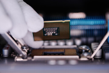 Extreme closeup of gloved hand of unrecognizable repairman placing CPU inside disassembled computer