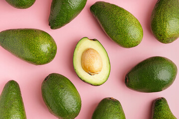 Fresh ripe avocados on pink background