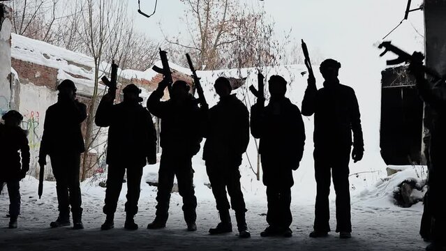 nine people poses with guns for Laser-tag game at winter day. Slow motion