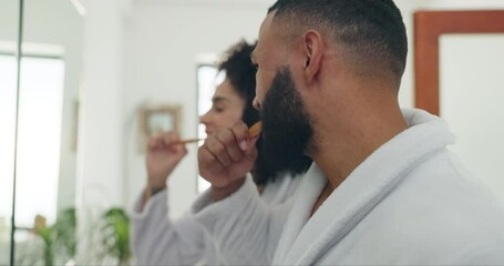 Couple, bathroom and brushing teeth for dental hygiene, care or morning routine together at home. Young man and woman with toothbrush for tooth whitening, grooming or getting ready in robes at house