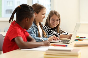 Cute children studying in classroom at school