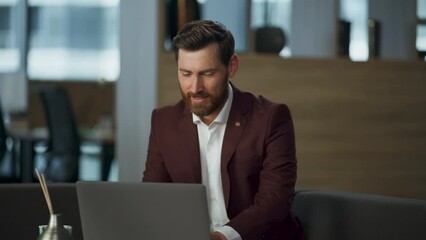 Cheerful man greeting hand video chat using modern laptop at office desk closeup