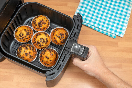 BAKING MUFFINS OR CUPCAKES WITH CHOCOLATE CHIPS IN AIR FRYER. SWEETS DESSERTS RECIPES. TOP VIEW.